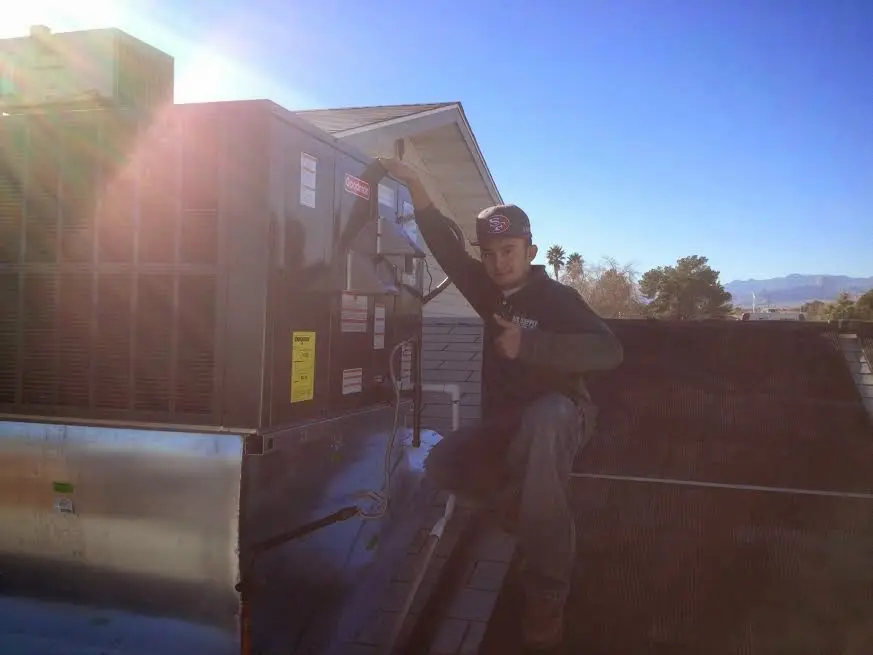 HVAC technician performing AC Tune-Up on a rooftop unit in Windsor Locks